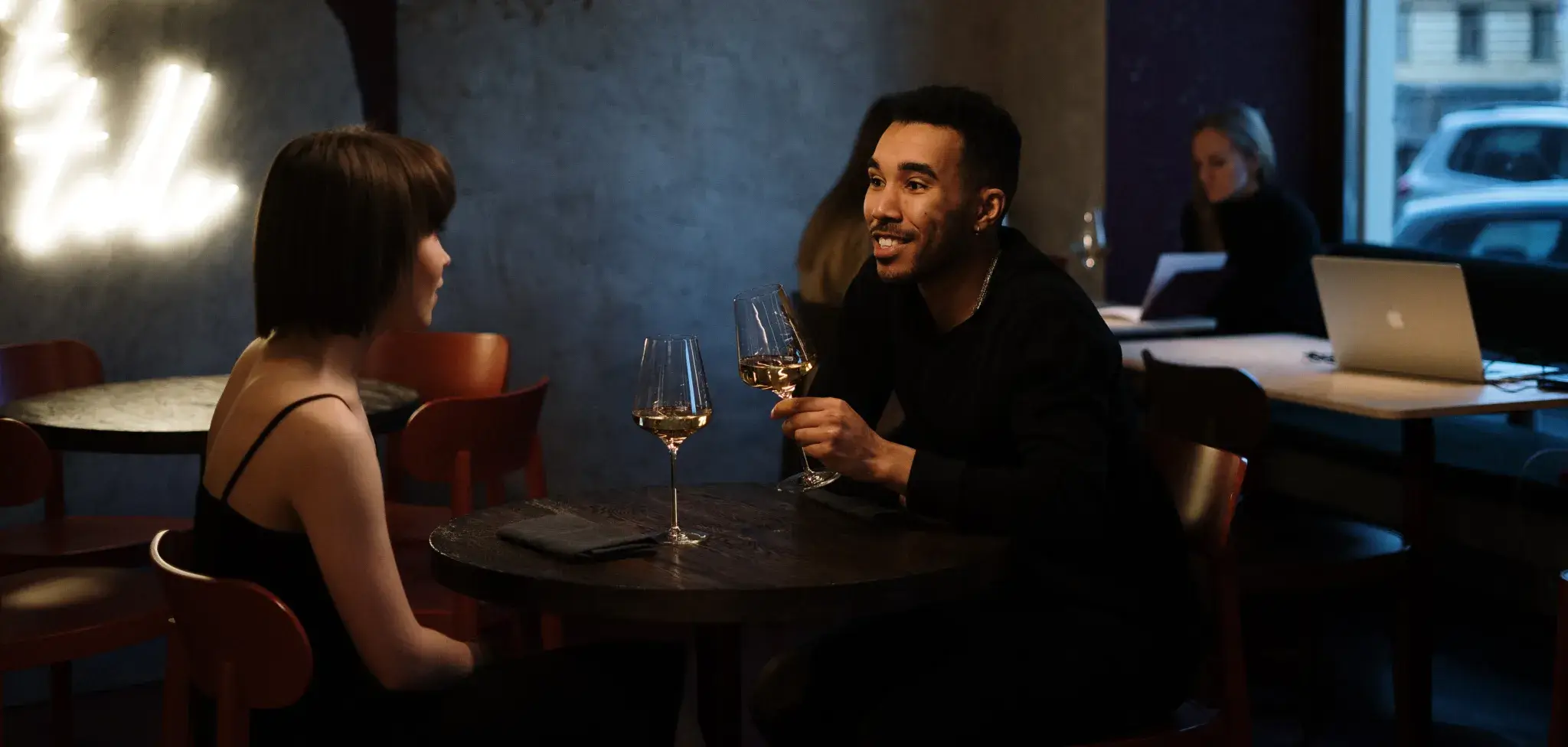 couple drinking wine at dimly lit table
